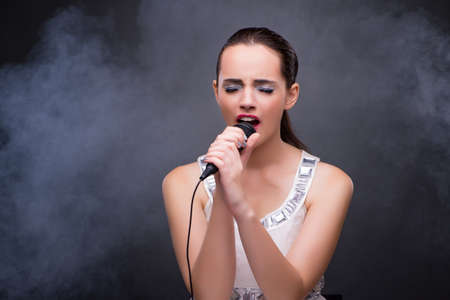 Young girl singing in karaoke clubの写真素材