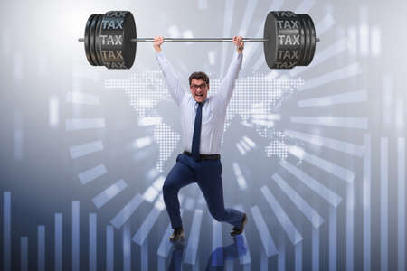 Businessman under  heavy burden of taxesの写真素材