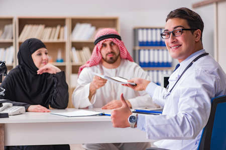 Doctor consulting arab family at hospitalの写真素材