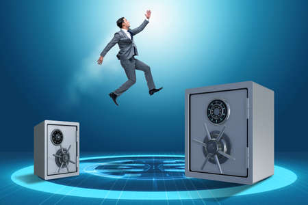 Businessman jumping from safes in business conceptの写真素材