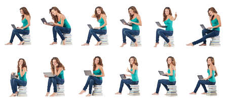 Student with netbook sitting on booksの写真素材