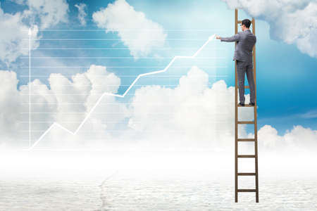 Businessman drawing charts in the skyの写真素材