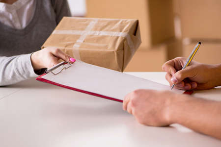 Delivery man delivering parcel boxの写真素材