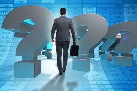 Businessman in uncertainty concept with question marksの写真素材