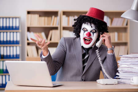 Clown businessman working in the officeの写真素材