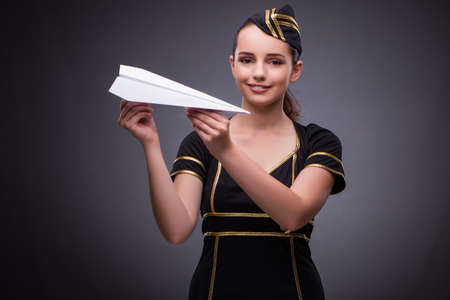 Young flight attendant on gray backgroundの写真素材