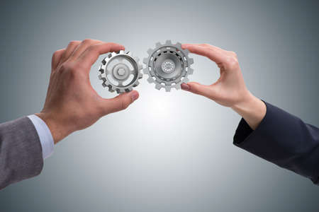 Businessman in teamwork concept with cogwheelsの写真素材