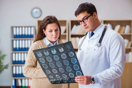 Young doctor looking at computer tomography x-ray image