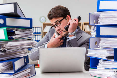 Busy businessman under stress due to excessive work