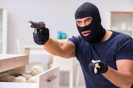 Robber wearing balaclava stealing valuable thingsの写真素材