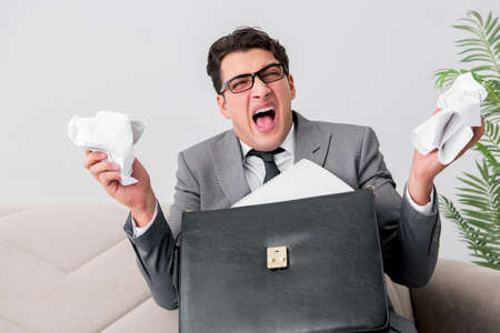 Angry businessman with crumbled paper