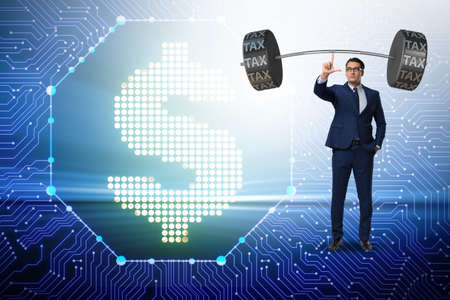 Businessman under  heavy burden of taxesの写真素材