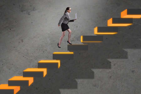Young businesswoman climbing career ladderの写真素材