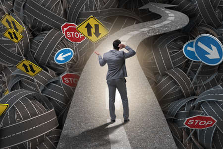 Businessman in uncertainty concept on road intersection crossroaの写真素材