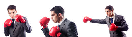 Businessman with boxing gloves on whiteの写真素材