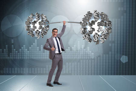 Businessman lifting barbell with dollarsの写真素材
