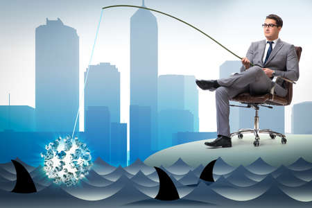 Businessman fishing out dollars from waterの写真素材