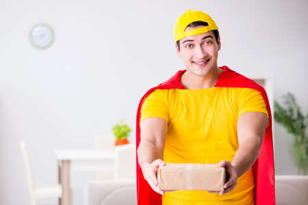 Superhero delivery guy with boxの写真素材