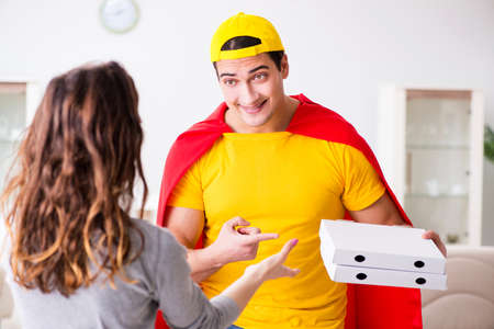 Superhero pizza delivery guy with red coverの写真素材