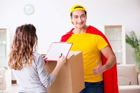 Superhero delivery guy with boxの写真素材
