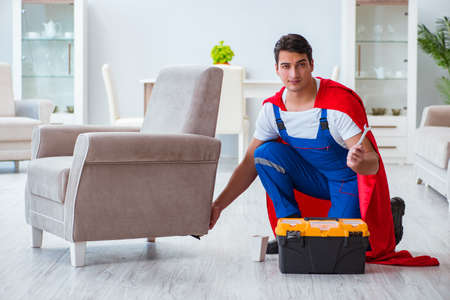 Super hero repairman working at homeの写真素材
