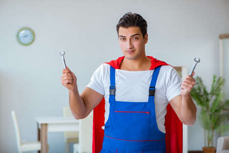 Super hero repairman working at homeの写真素材