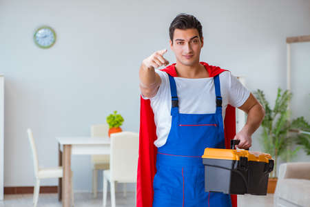 Super hero repairman working at homeの写真素材