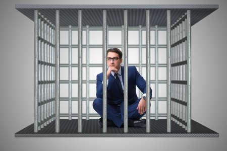 Businessman in the cage business conceptの写真素材