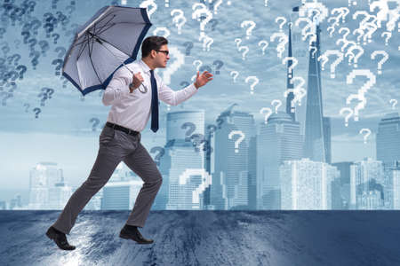 Uncertainty concept with businessman and question marksの写真素材
