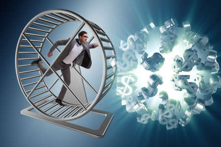 Business concept with businessman running on hamster wheelの写真素材