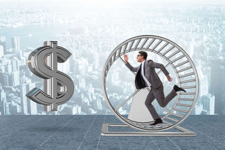 Business concept with businessman running on hamster wheelの写真素材