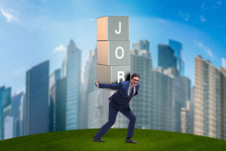 Businessman carrying the burden of his jobの写真素材