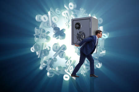 BUsinessman stealing metal safe from bankの写真素材