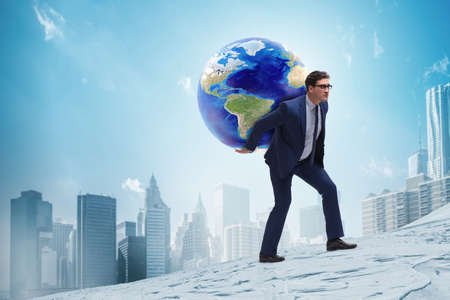 Businessman carrying Earth on his shouldersの写真素材
