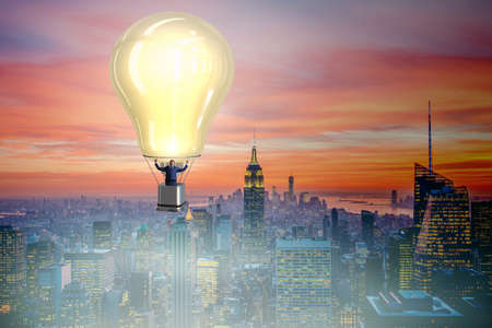 Businessman flying on hot balloonの写真素材