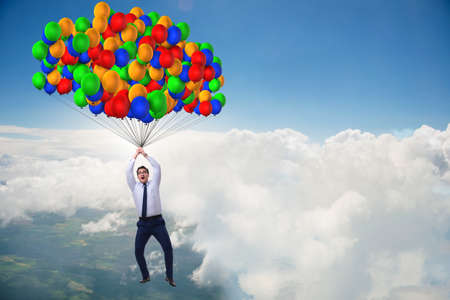Businessman flying on balloons in challenge conceptの写真素材