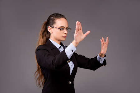 Young woman businesswoman pressing virtual buttonsの写真素材