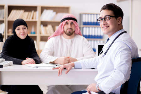 Doctor consulting arab family at hospitalの写真素材