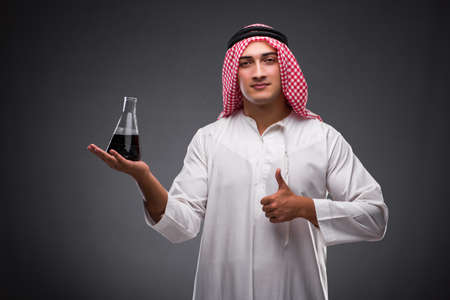 Arab with oil on gray backgroundの写真素材
