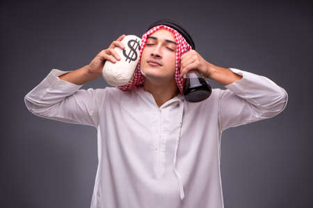 Arab with oil on gray backgroundの写真素材