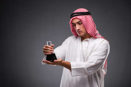 Arab with oil on gray backgroundの写真素材