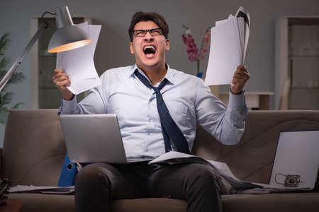 Businessman workaholic working late at home