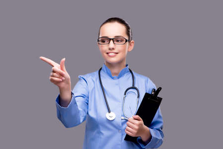 Young doctor pressing virtual buttonの写真素材