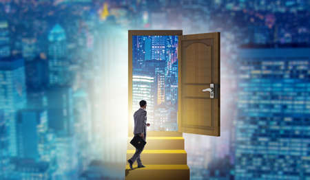 Businessman walking towards open doorの写真素材