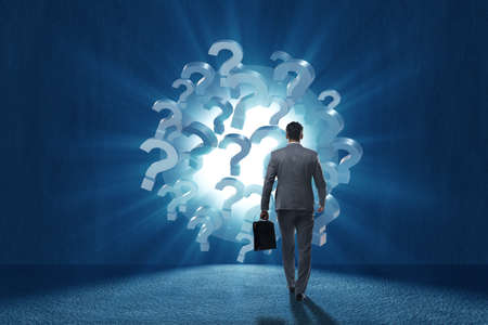 Businessman in uncertainty concept with question marksの写真素材