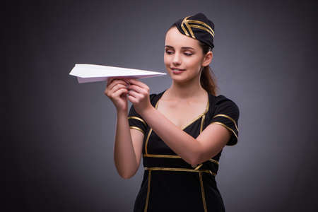 Young flight attendant on gray backgroundの写真素材