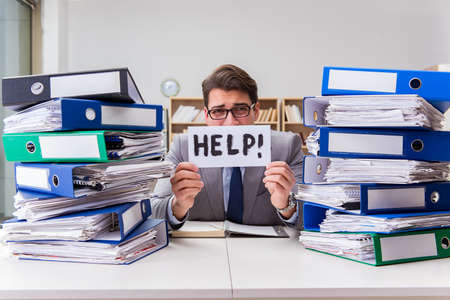Busy businessman asking for help with workの写真素材