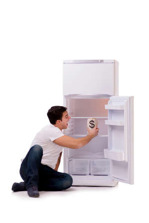 Hungry man looking for money to fill the fridgeの写真素材