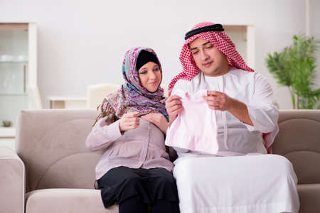 Young arab muslim family with pregnant wife expecting babyの写真素材