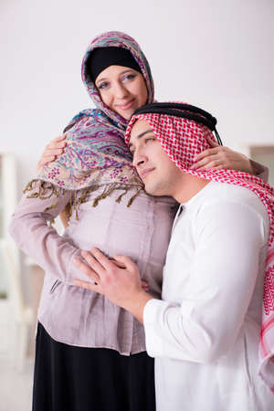 Young arab muslim family with pregnant wife expecting babyの写真素材